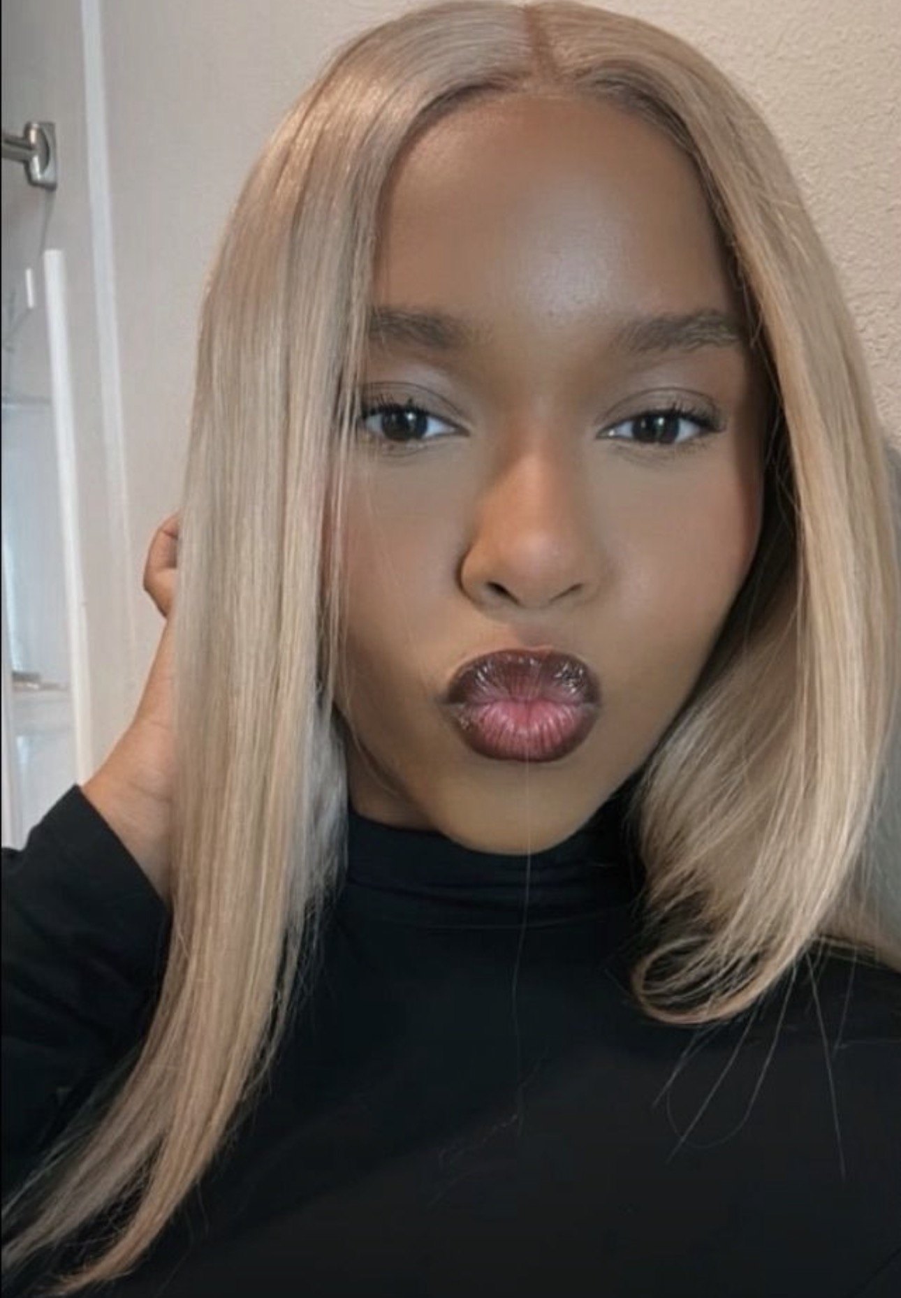 Portrait of Taylented with blonde hair and a black top